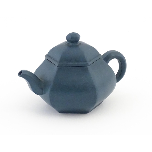 61 - A Chinese Yixing teapot of hexagonal form with a blue ground. Character marks under and to underside... 