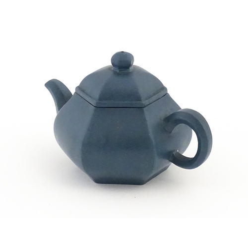 61 - A Chinese Yixing teapot of hexagonal form with a blue ground. Character marks under and to underside... 