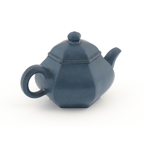 61 - A Chinese Yixing teapot of hexagonal form with a blue ground. Character marks under and to underside... 