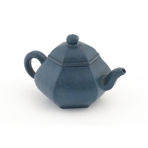 61 - A Chinese Yixing teapot of hexagonal form with a blue ground. Character marks under and to underside... 