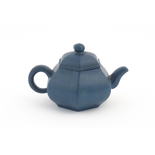 61 - A Chinese Yixing teapot of hexagonal form with a blue ground. Character marks under and to underside... 