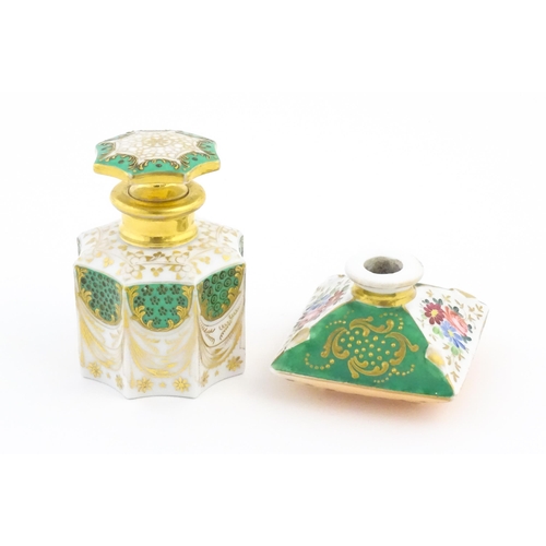 66 - A French porcelain scent / perfume bottle of octagonal form with gilt foliate decoration. Marked und... 