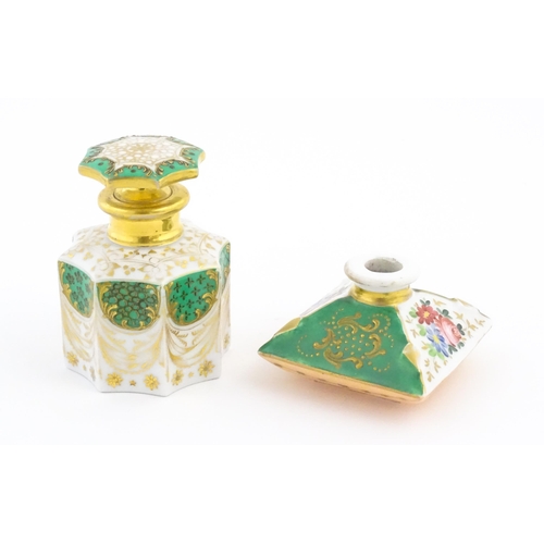 66 - A French porcelain scent / perfume bottle of octagonal form with gilt foliate decoration. Marked und... 