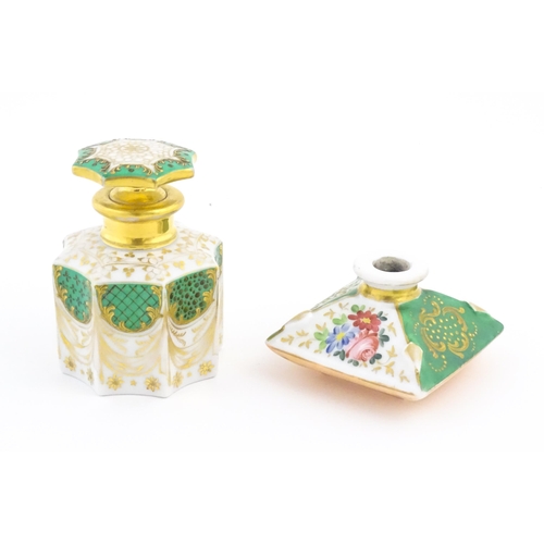 66 - A French porcelain scent / perfume bottle of octagonal form with gilt foliate decoration. Marked und... 