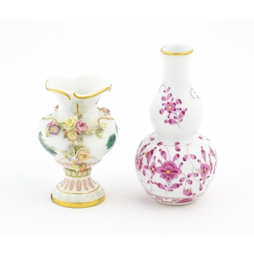 67 - Two small Continental vases comprising a double gourd vase with scrolling floral and foliate detail,... 