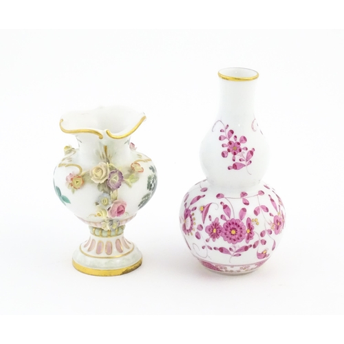 67 - Two small Continental vases comprising a double gourd vase with scrolling floral and foliate detail,... 