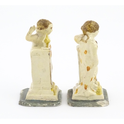 70 - A pair of English creamware pottery Classical figures with column detail. Approx. 4 3/4