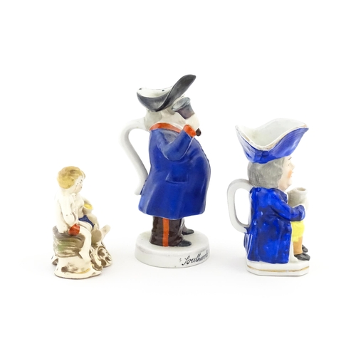 71 - Three assorted ceramic figures to include a Toby / character jug modelled as a seated man wearing a ... 