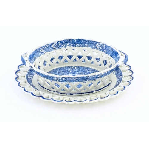 76 - A Spode blue and white twin handled chestnut basket and stand decorated in the Chinoiserie Net patte... 