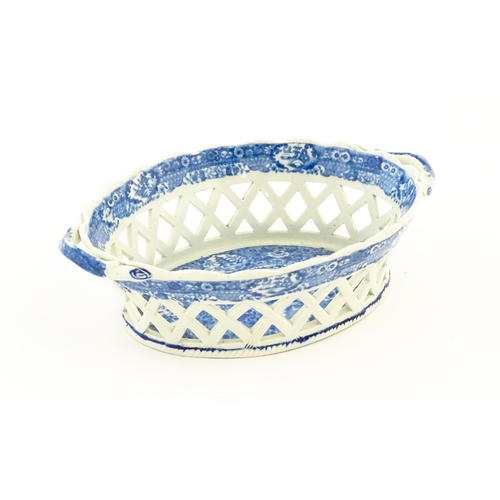 76 - A Spode blue and white twin handled chestnut basket and stand decorated in the Chinoiserie Net patte... 