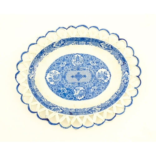 76 - A Spode blue and white twin handled chestnut basket and stand decorated in the Chinoiserie Net patte... 