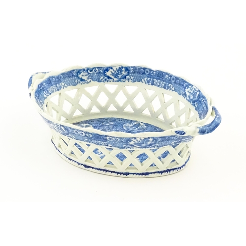 76 - A Spode blue and white twin handled chestnut basket and stand decorated in the Chinoiserie Net patte... 