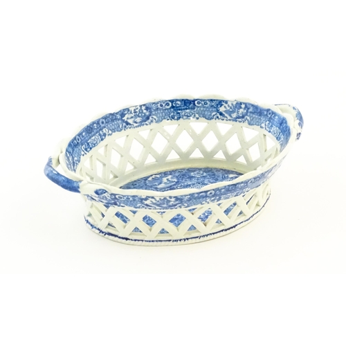 76 - A Spode blue and white twin handled chestnut basket and stand decorated in the Chinoiserie Net patte... 