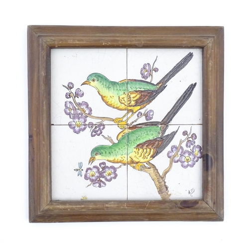 84 - Four hand painted tiles framed together depicting two birds perched on a branch with blossom. Signed... 