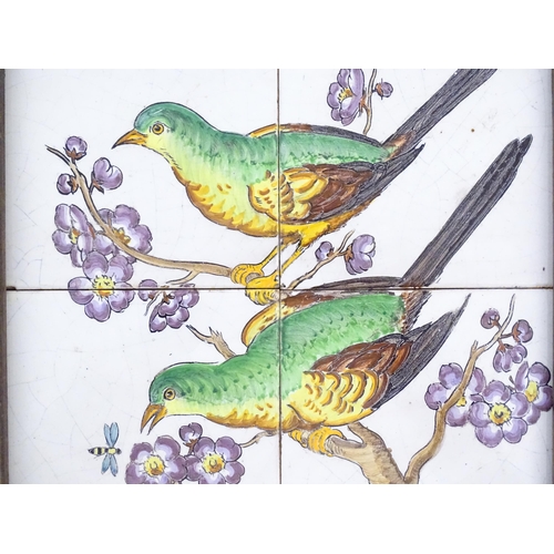 84 - Four hand painted tiles framed together depicting two birds perched on a branch with blossom. Signed... 