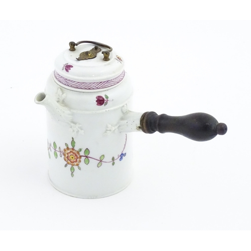 88 - A Continental chocolate pot and cover of cylindrical form with side spout and turned wooden handle, ... 