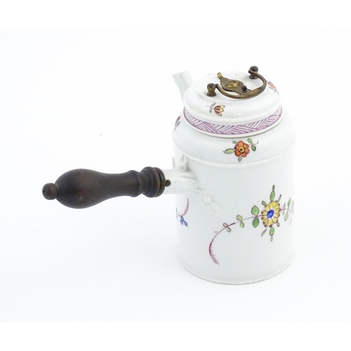 88 - A Continental chocolate pot and cover of cylindrical form with side spout and turned wooden handle, ... 