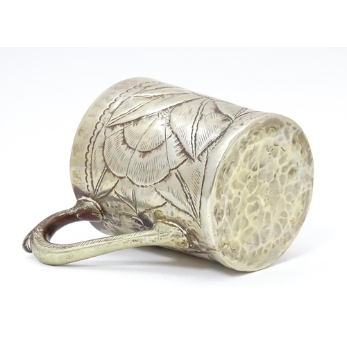 1005 - An Arts & Crafts silver plate mug with engraved flower / rose head decoration. Approx. 4