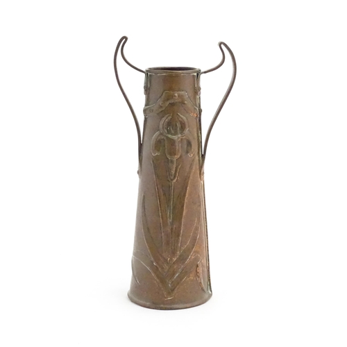 1006 - An Art Nouveau twin handled copper vase with embossed floral and foliate motifs. Approx. 11 1/4