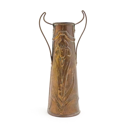 1006 - An Art Nouveau twin handled copper vase with embossed floral and foliate motifs. Approx. 11 1/4