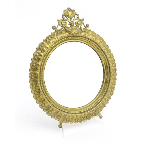 1023 - A late 19th / early 20thC mirror of circular form with bevelled glass, the brass frame with banded a... 