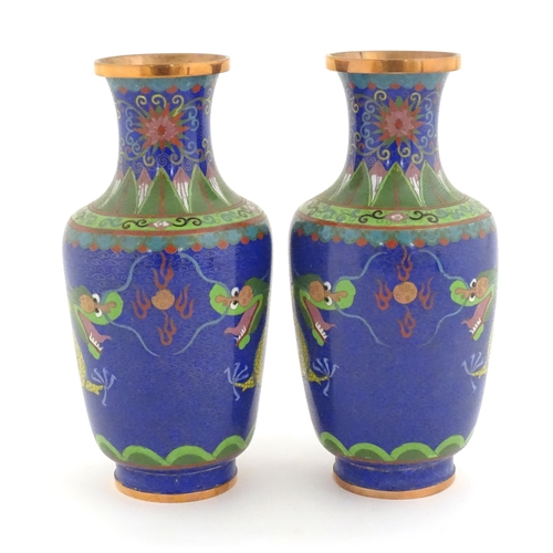 1026 - A pair of Oriental cloisonne vases decorated with two dragons and a flaming pearl amongst stylised c... 