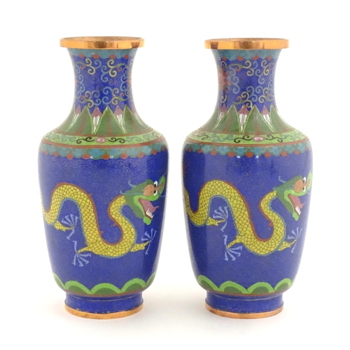 1026 - A pair of Oriental cloisonne vases decorated with two dragons and a flaming pearl amongst stylised c... 