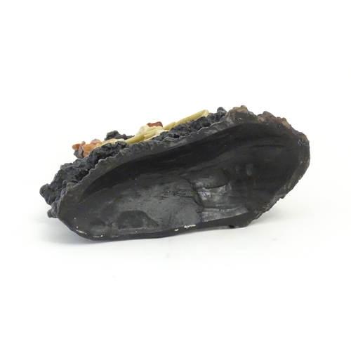 1028 - An Oriental soapstone carving depicting a rocky outcrop with immortal figures amongst clouds. Approx... 