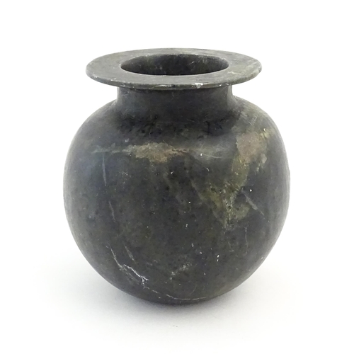 1029 - An Oriental soapstone vase of bulbous form. Approx. 5 1/4