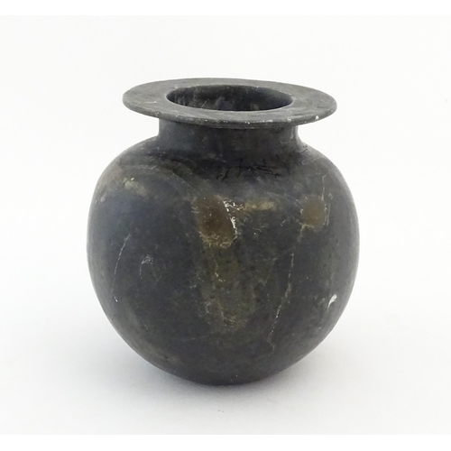 1029 - An Oriental soapstone vase of bulbous form. Approx. 5 1/4