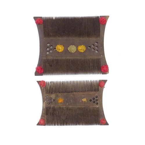 1033 - Two wooden shaped and double sided combs with pierced and thread detail. Largest approx. 5 1/2