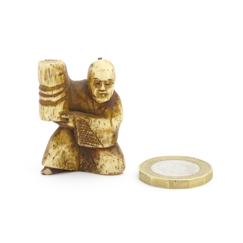 1038 - An Oriental carved bone netsuke modelled as a seated man holding a vase. Approx. 1 1/2