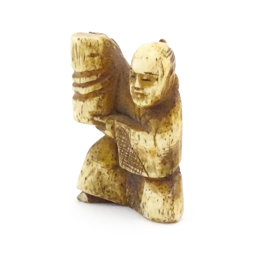 1038 - An Oriental carved bone netsuke modelled as a seated man holding a vase. Approx. 1 1/2