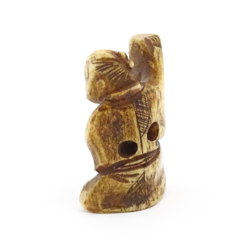 1038 - An Oriental carved bone netsuke modelled as a seated man holding a vase. Approx. 1 1/2