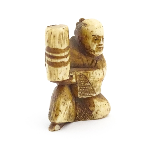 1038 - An Oriental carved bone netsuke modelled as a seated man holding a vase. Approx. 1 1/2