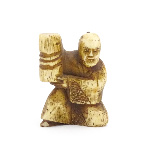 1038 - An Oriental carved bone netsuke modelled as a seated man holding a vase. Approx. 1 1/2