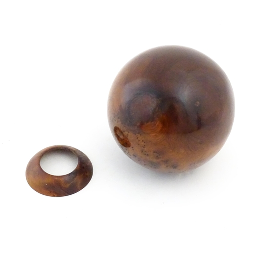 1059 - A 20thC burr yew wooden sphere / ball on a wooden base. Approx. 5 1/4