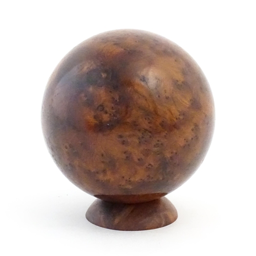 1059 - A 20thC burr yew wooden sphere / ball on a wooden base. Approx. 5 1/4