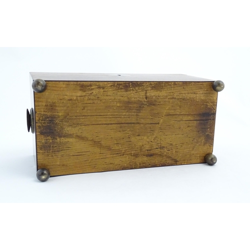 1062 - A 19thC rosewood tea caddy of sarcophagus form with twin roundel handles and ball feet. The interior... 