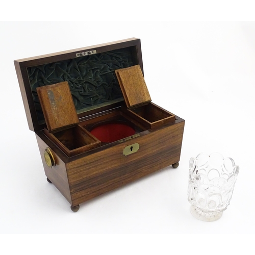 1062 - A 19thC rosewood tea caddy of sarcophagus form with twin roundel handles and ball feet. The interior... 