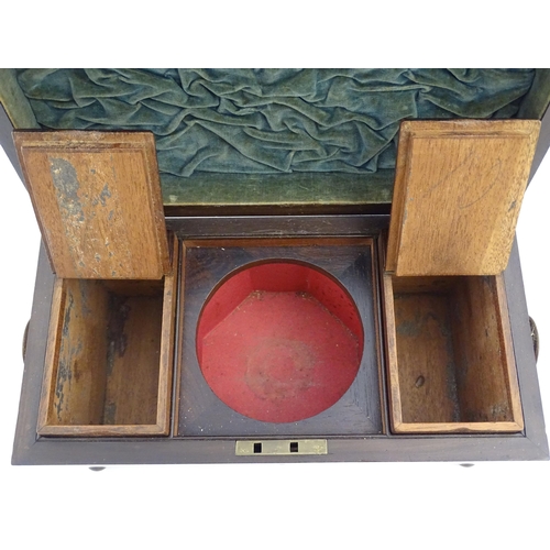 1062 - A 19thC rosewood tea caddy of sarcophagus form with twin roundel handles and ball feet. The interior... 