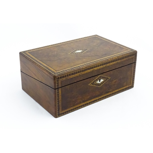 1065 - A late 19th / early 20thC walnut writing slope, the  burr walnut top and front with marquetry and mo... 