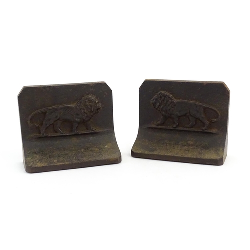 1066 - A pair of 20thC Bradley & Hubbard cast iron bookends with relief lion detail. Marked B&H to reverse.... 