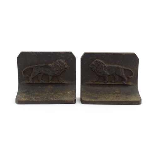 1066 - A pair of 20thC Bradley & Hubbard cast iron bookends with relief lion detail. Marked B&H to reverse.... 