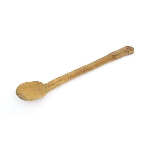 1079 - A naive carved wooden spoon. Approx. 20