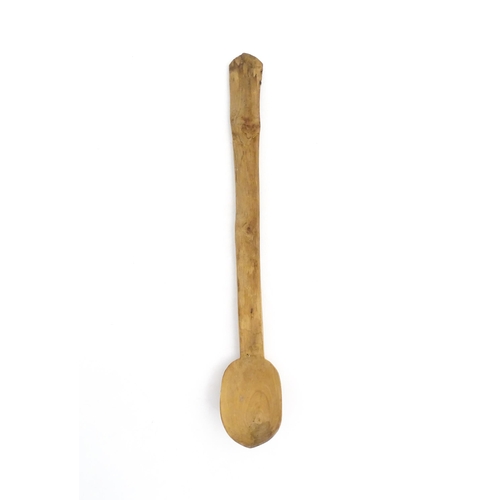 1079 - A naive carved wooden spoon. Approx. 20