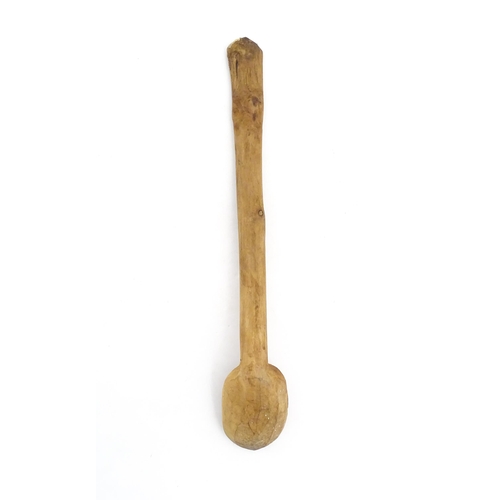 1079 - A naive carved wooden spoon. Approx. 20