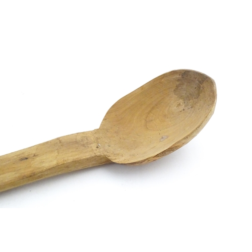 1079 - A naive carved wooden spoon. Approx. 20