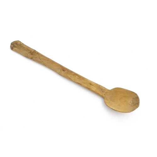 1079 - A naive carved wooden spoon. Approx. 20