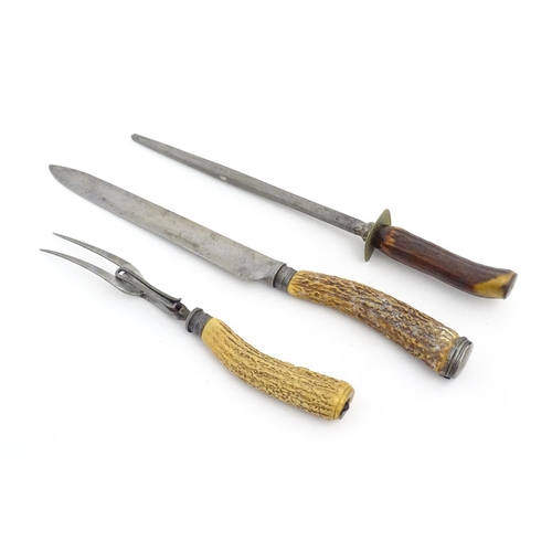 1083 - A Victorian carving knife and fork with antler handles and silver collar. Together with an antler ha... 